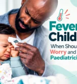 Child with fever being checked with a thermometer by a parent.